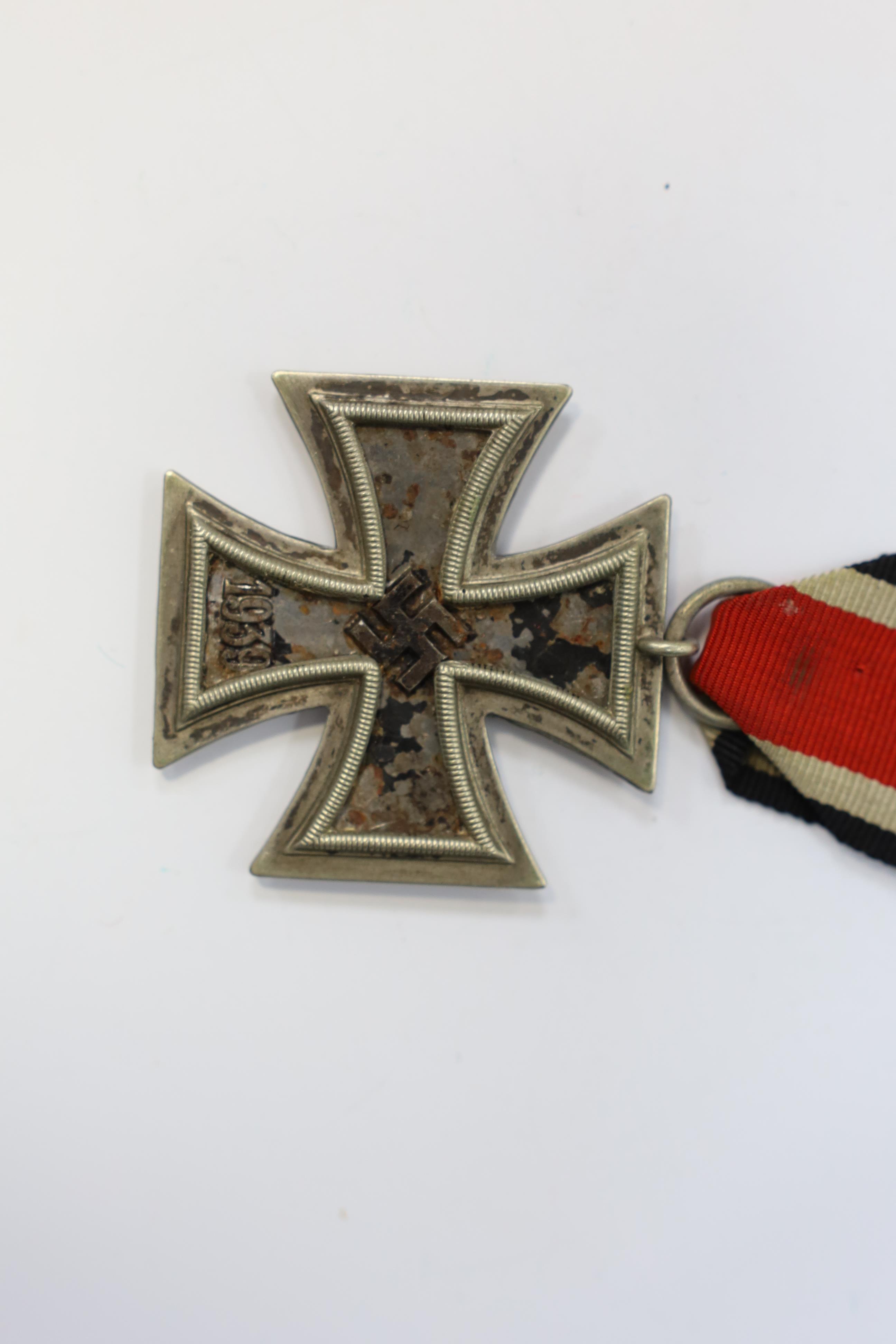 A WWII Iron Cross. Condition - poor, black paint now mainly missing from surface.